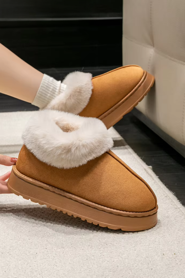Margo & Main – Chestnut slipper booties held above a rug, sole and toe view, US women's sizes