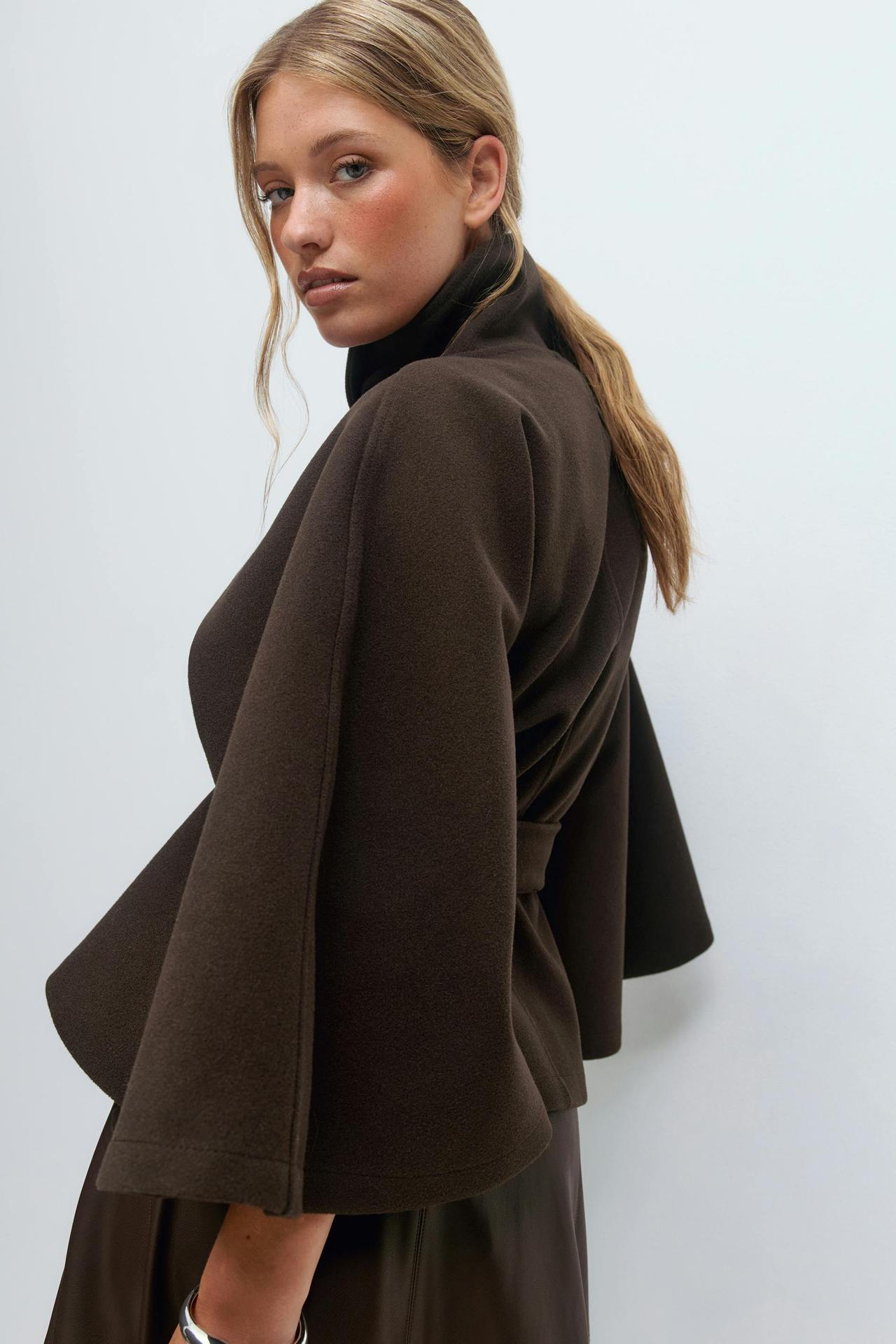 Margo & Main – Anneke chocolate brown button-front belted cape coat, side view showing the flared cape sleeve, US women's sizes