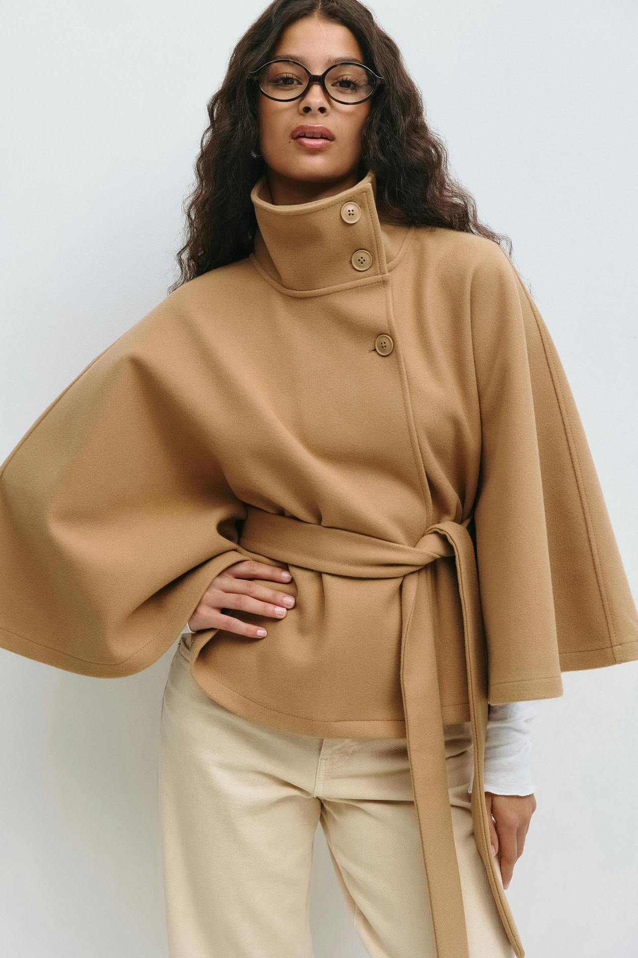 Margo & Main – Anneke camel button-front belted cape coat, waist-up front view with hand on hip, US women's sizes