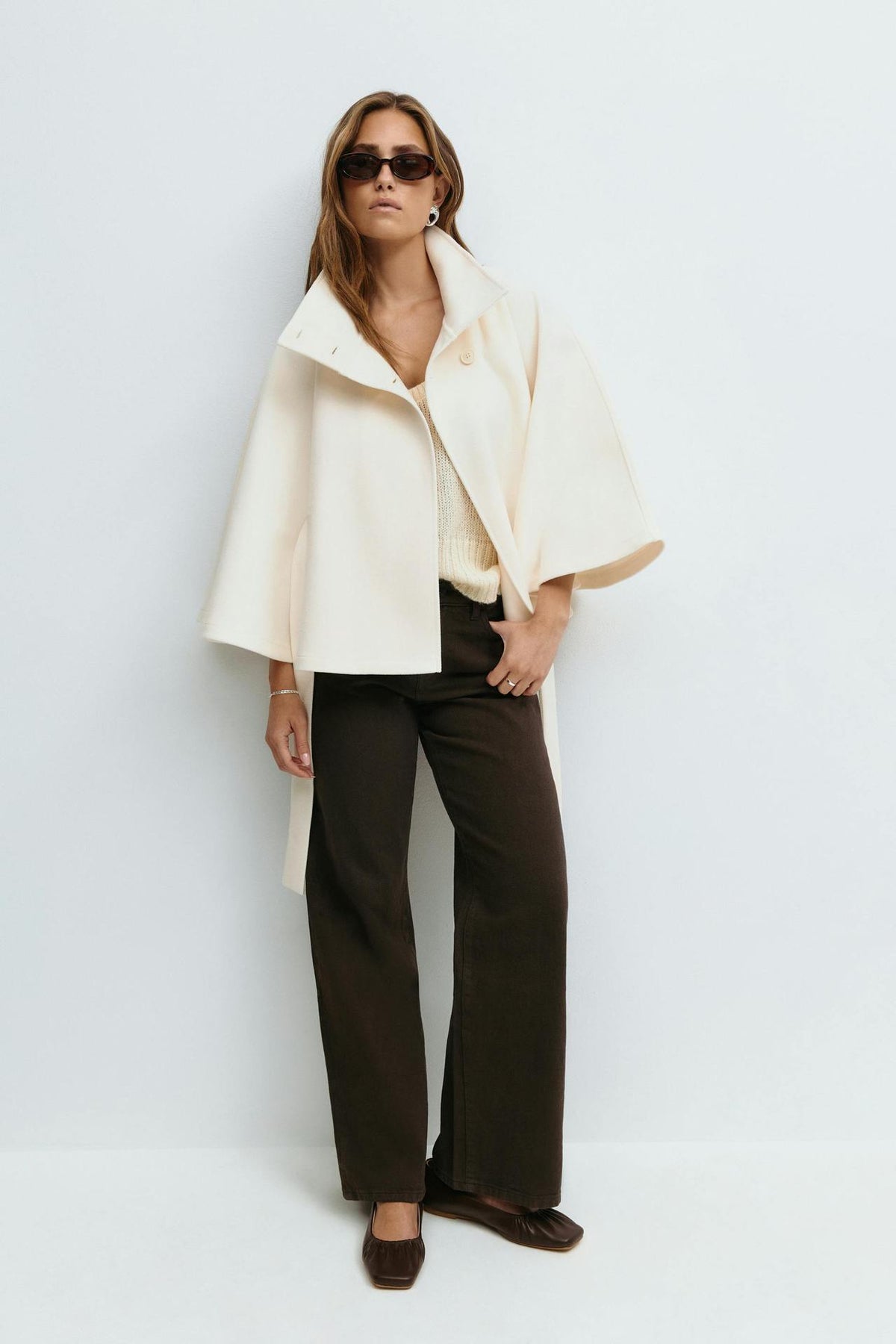 Margo & Main – Anneke ivory button-front belted cape coat, full-length front view worn open with brown trousers, US women's sizes