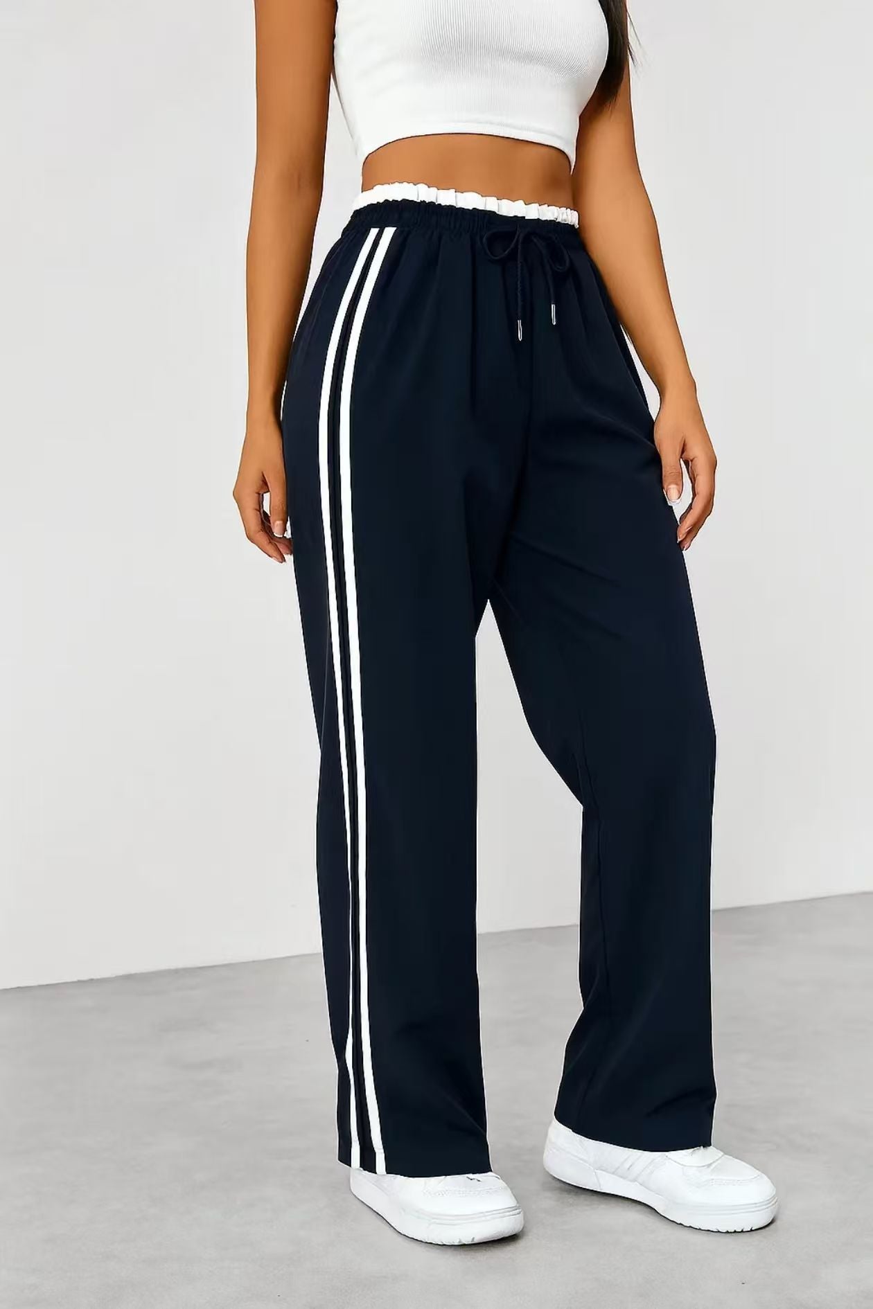 Margo & Main – Fausta navy side-stripe pull-on track pants, cropped view of the drawstring waist styled with white sneakers, US women's sizes