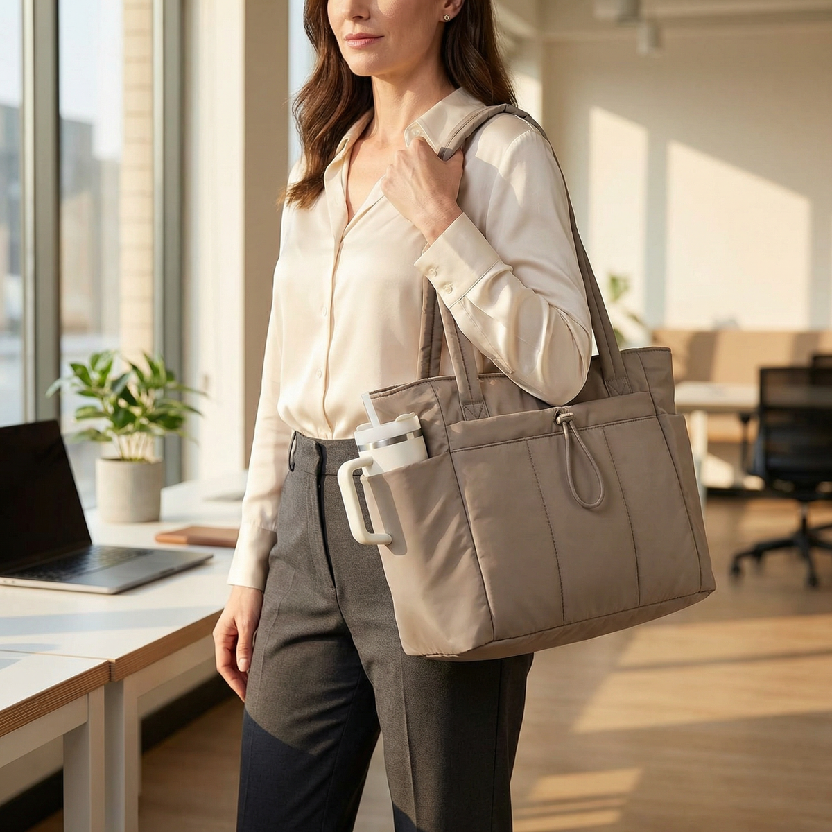 Margo & Main – Tova tan quilted tote worn in an office with a tumbler in the side pocket