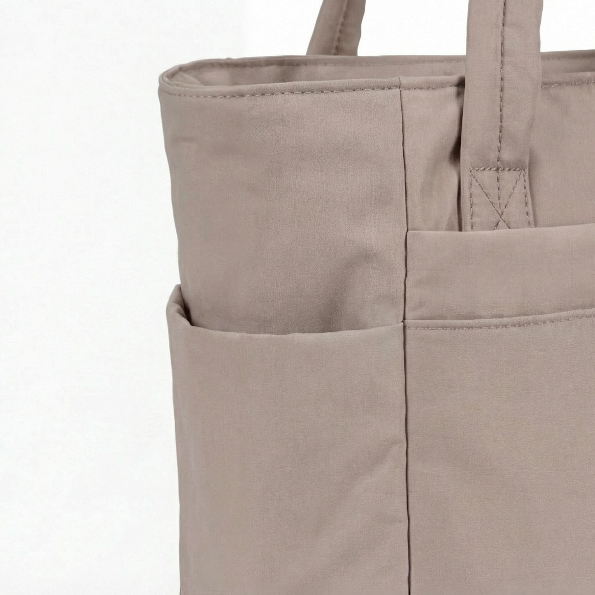Margo & Main – Tova tan quilted tote, close-up of the deep open side pockets and seams