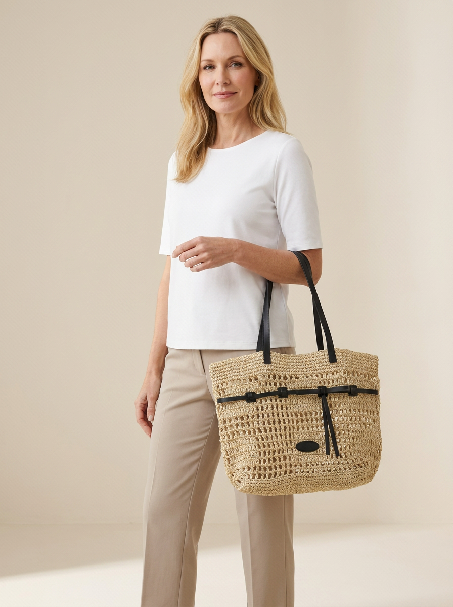 Marina Woven Tote Bag in Yellow carried by a confident woman in a clean studio setting.