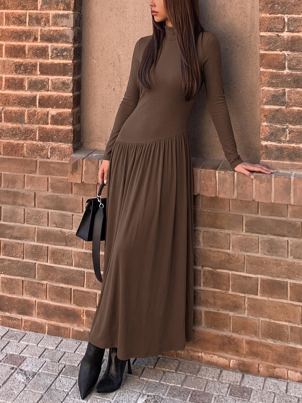 Margo & Main brown mock neck drop-waist long sleeve maxi dress — leaning pose, gathered skirt