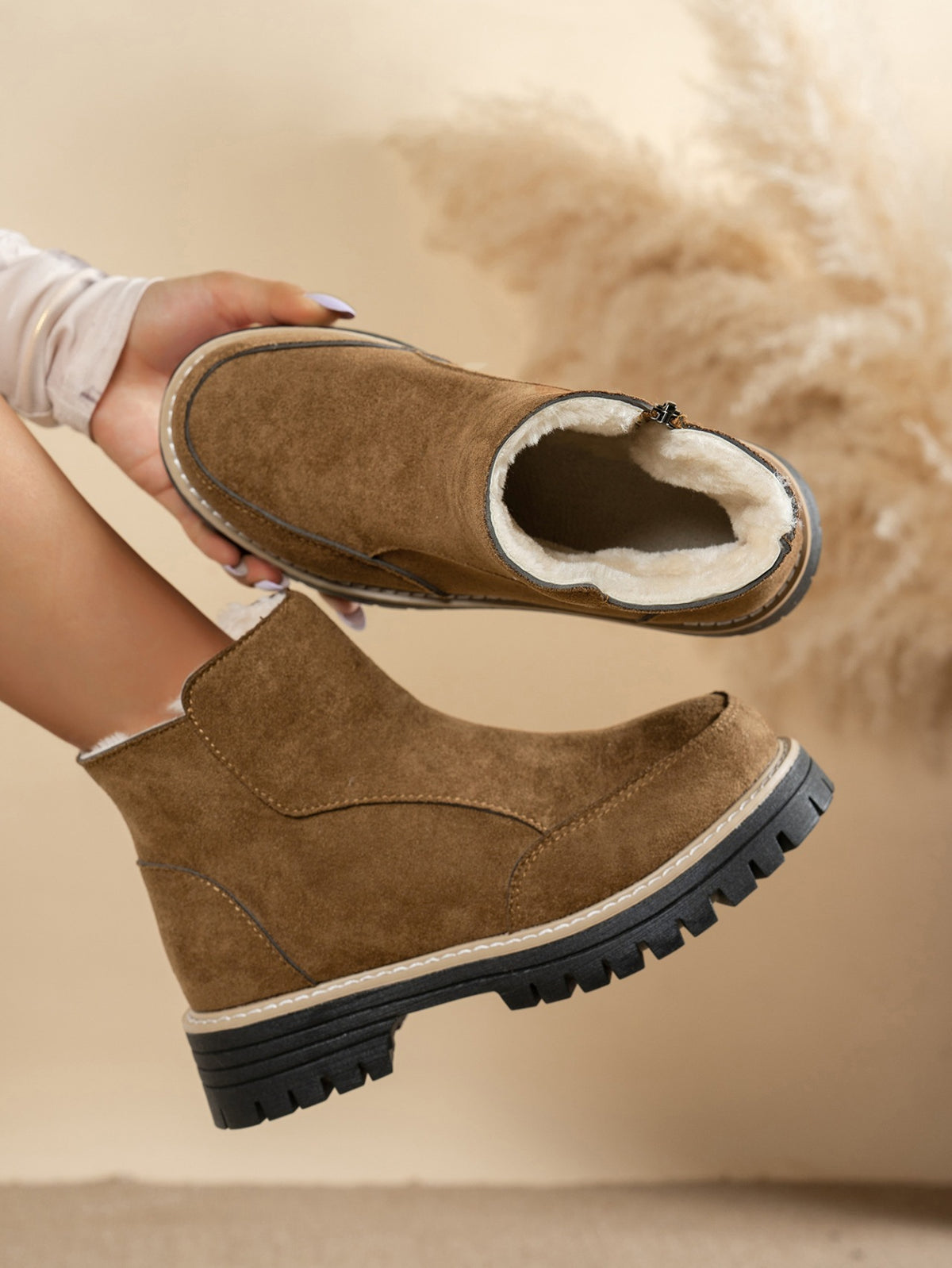 Margo & Main brown plush-lined side-zip ankle boots — boot held to show the plush lining, US women's sizes