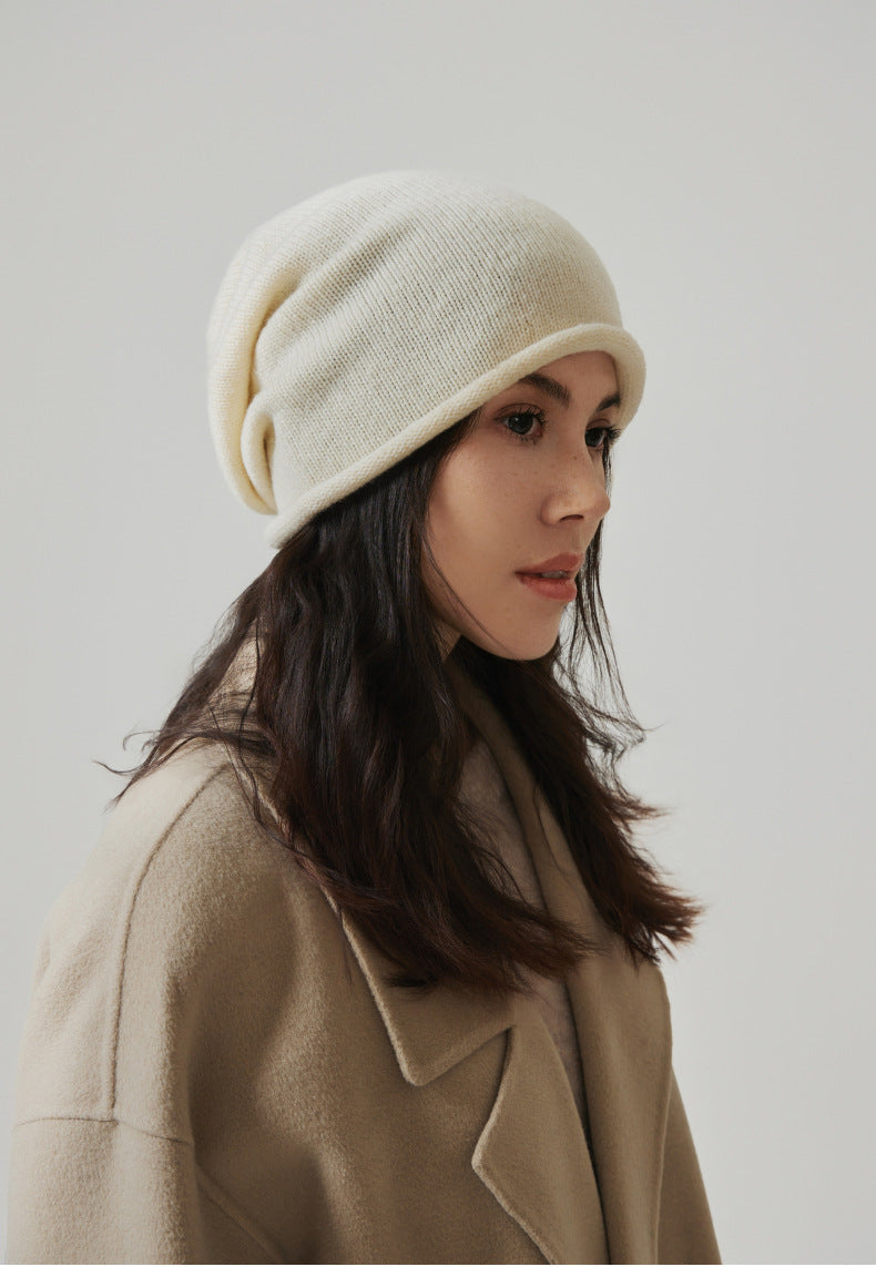 Margo & Main white wool beanie — side profile of the rolled brim, styled with a camel coat