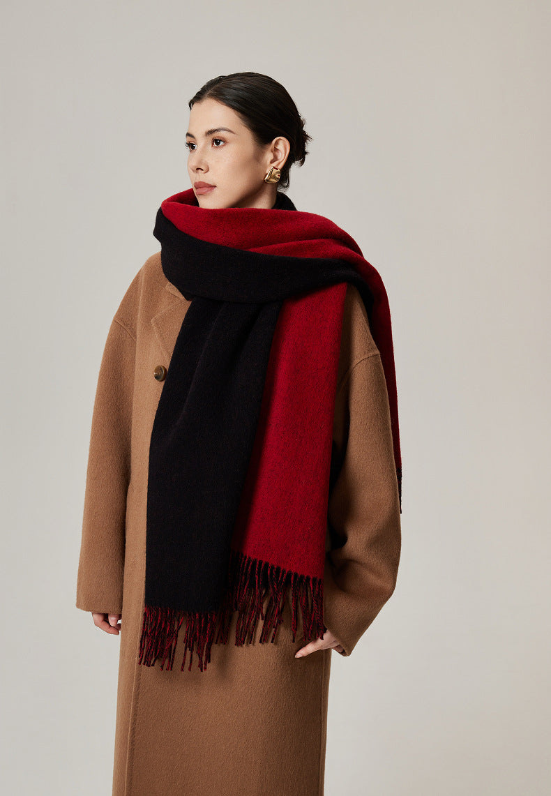 Margo & Main red lamb wool blanket scarf — front view over a camel coat, black reverse showing