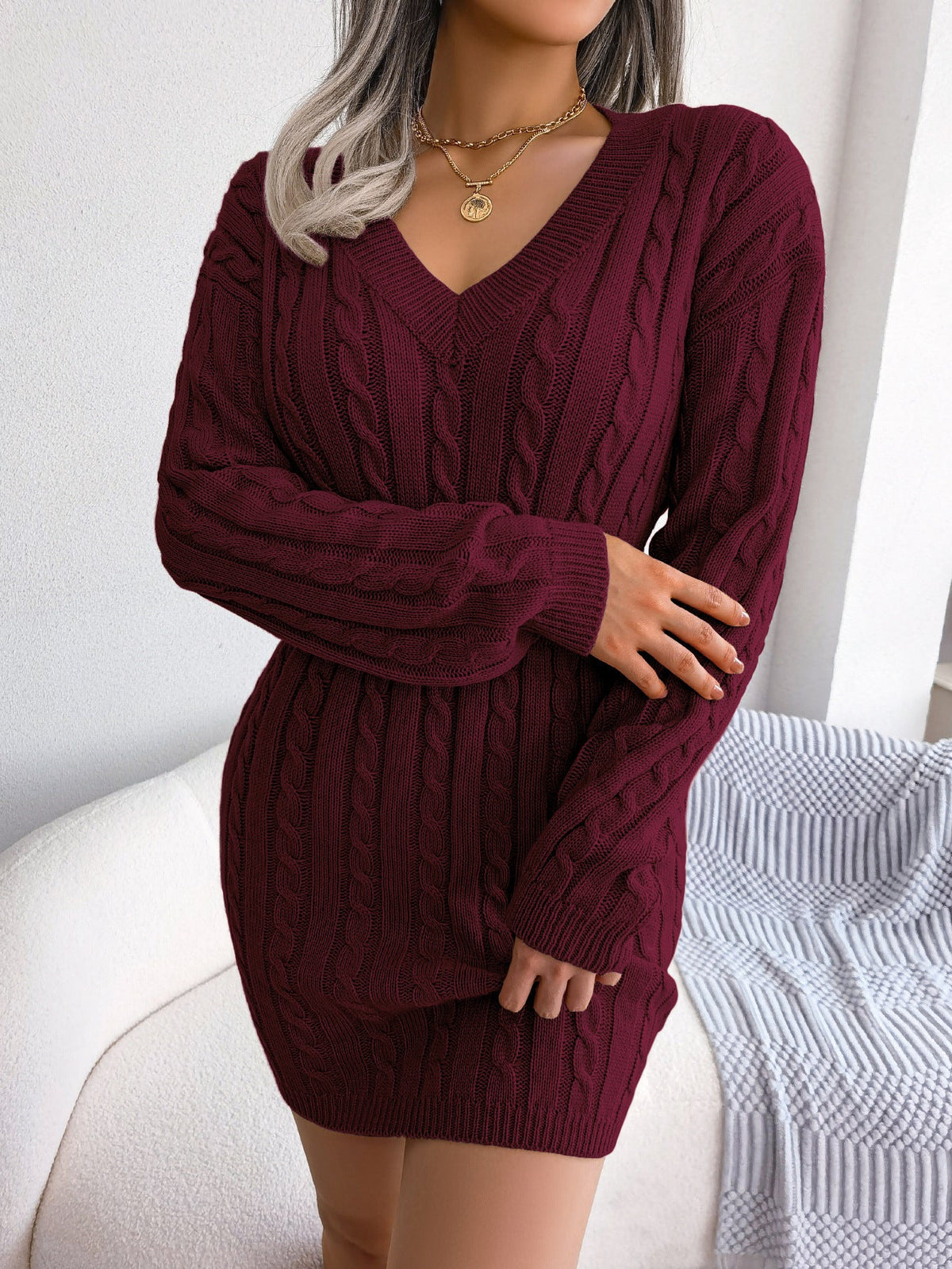 Cable-knit smocked-waist sweater dress as a Thanksgiving outfit for women over 50