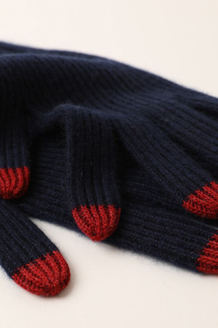 Margo & Main - navy cashmere gloves laid flat, close detail of the red fingertips, one size