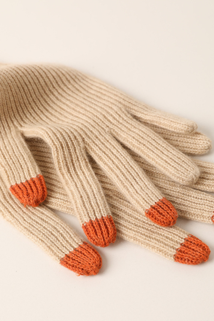 Margo & Main - beige cashmere gloves laid flat showing orange contrast fingertips, one size