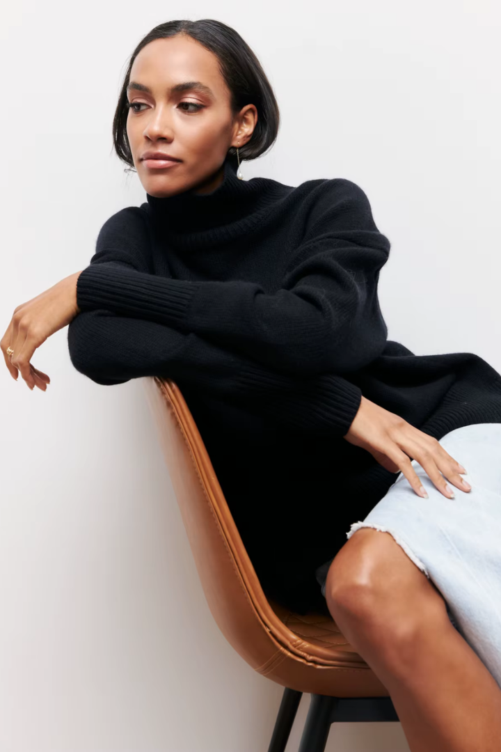 Margo & Main – black oversized turtleneck sweater seated styled lifestyle view, US women's sizes