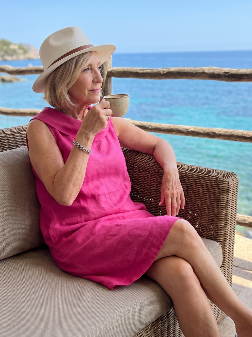 Margo & Main – Vienna Pink sleeveless linen shift dress, seated styling view, US women’s sizes