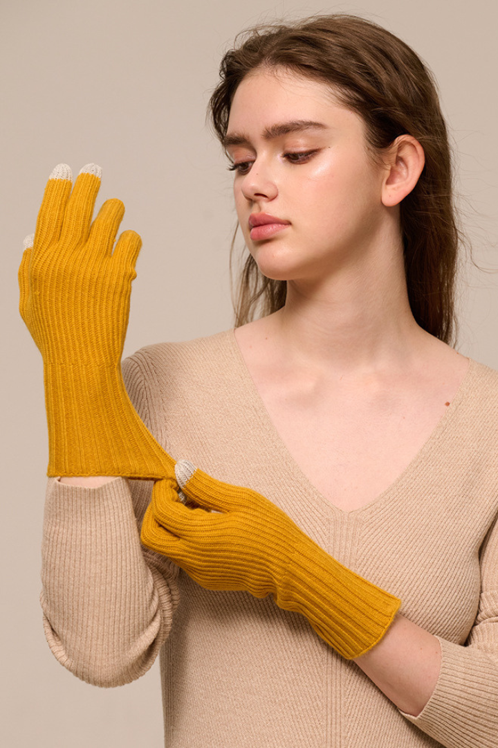 Margo & Main - mustard yellow cashmere gloves, hands raised to show the long ribbed cuff, one size