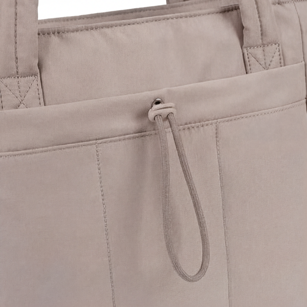 Margo & Main – Tova tan quilted tote, close-up of the front slip pocket and drawstring pull