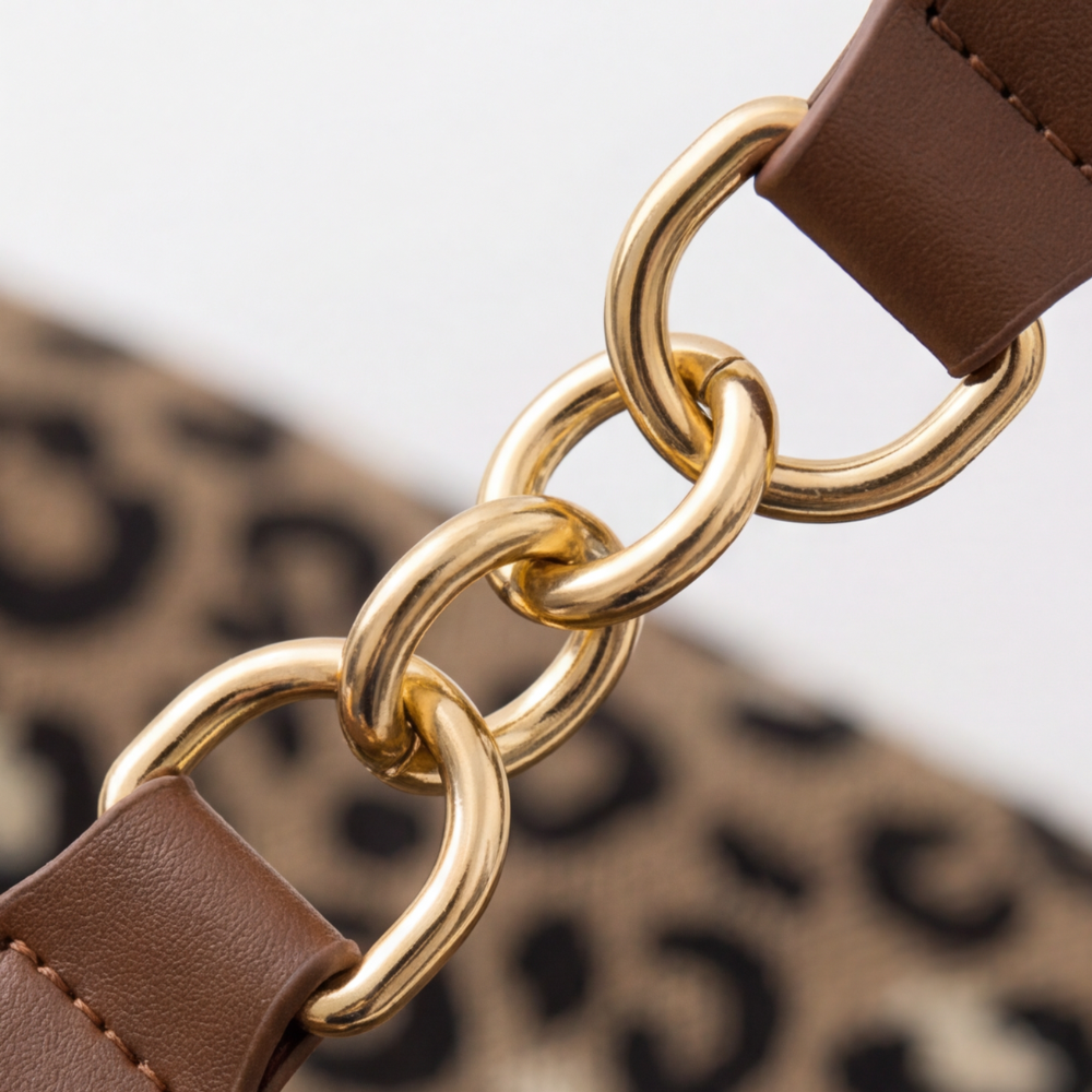 Margo & Main – Lynxe brown leopard canvas bag, macro detail of the gold-tone chain links