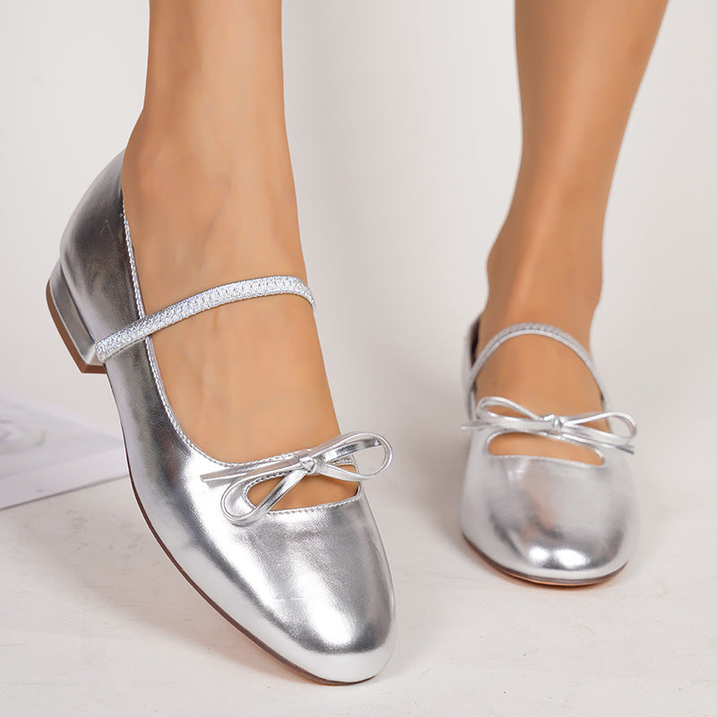 Margo & Main – Silver Patent Bow Strap Mary Jane Flats worn on a model, side view, US women's sizes