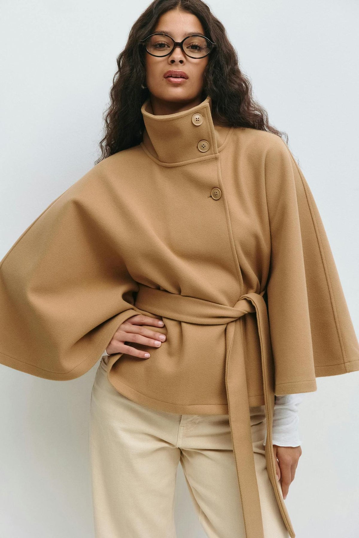 Margo & Main – Anneke camel button-front belted cape coat, waist-up front view with hand on hip, US women's sizes