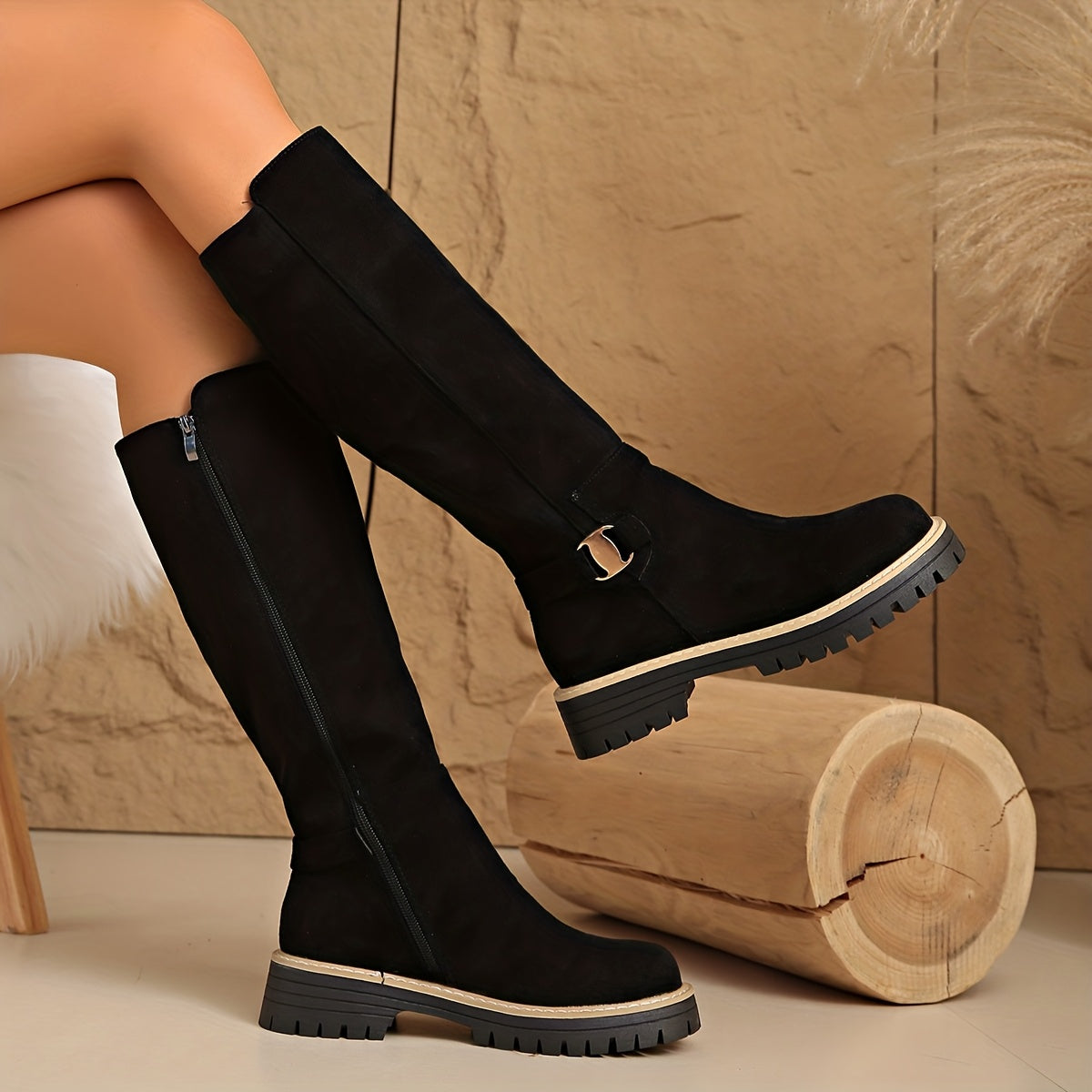 Margo & Main – black lug sole knee high boots worn seated on a model, US women’s sizes