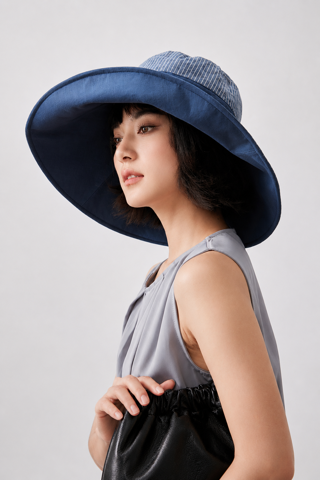 Margo & Main – Carmela blue reversible foldable sun hat in side profile, showing the striped reverse face under the brim