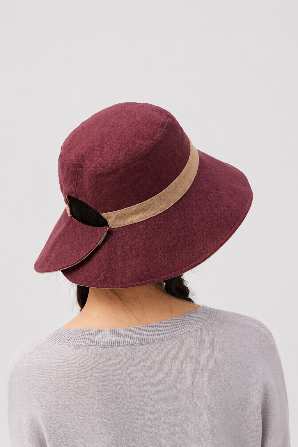Margo & Main – Sabella reversible sun hat turned to its burgundy side with a tan band, back view showing the adjustable tab