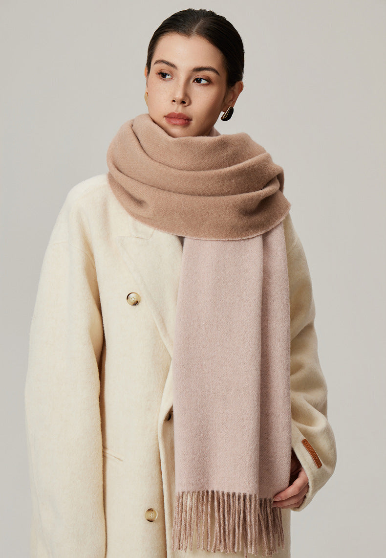 Margo & Main tan lamb wool blanket scarf — front view over a cream coat, blush reverse showing