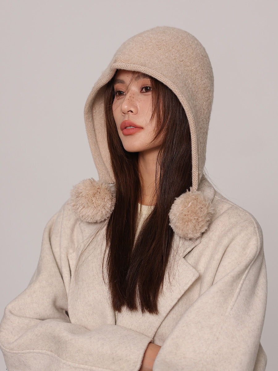Margo & Main cream wool pom pom hood — three-quarter view with the poms on the shoulder