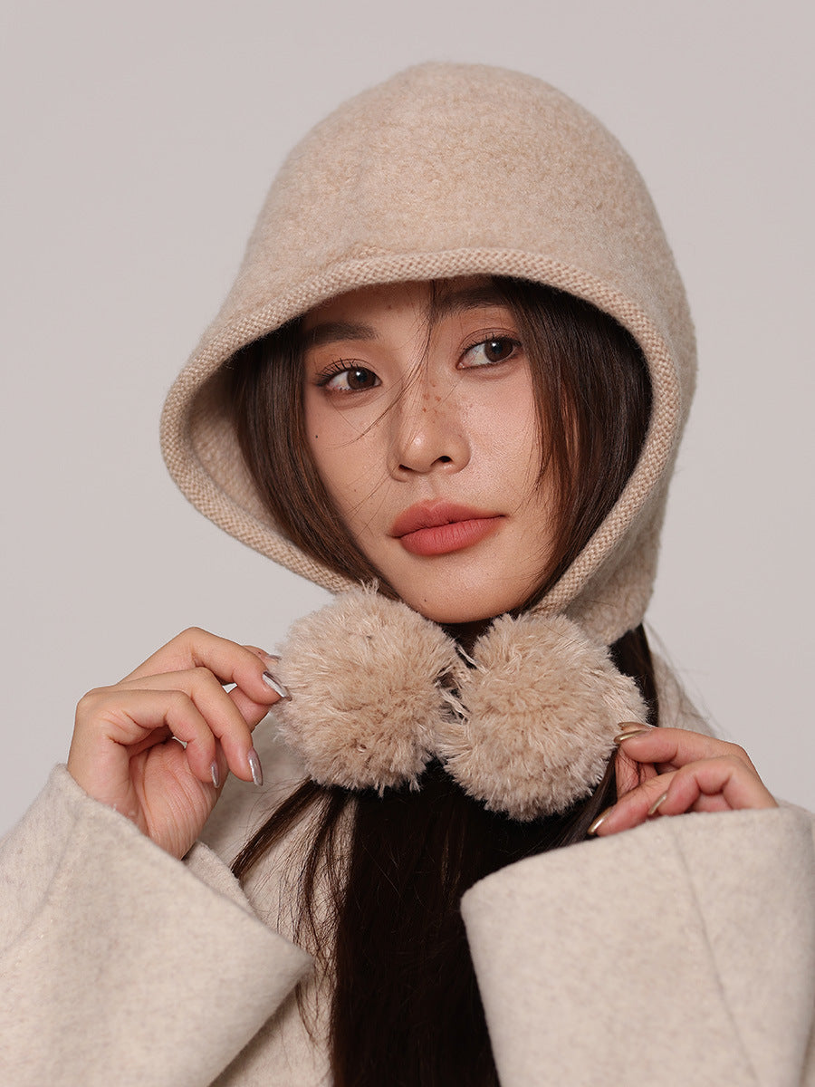 Margo & Main cream wool pom pom hood — close-up of the pom pom ties held in both hands