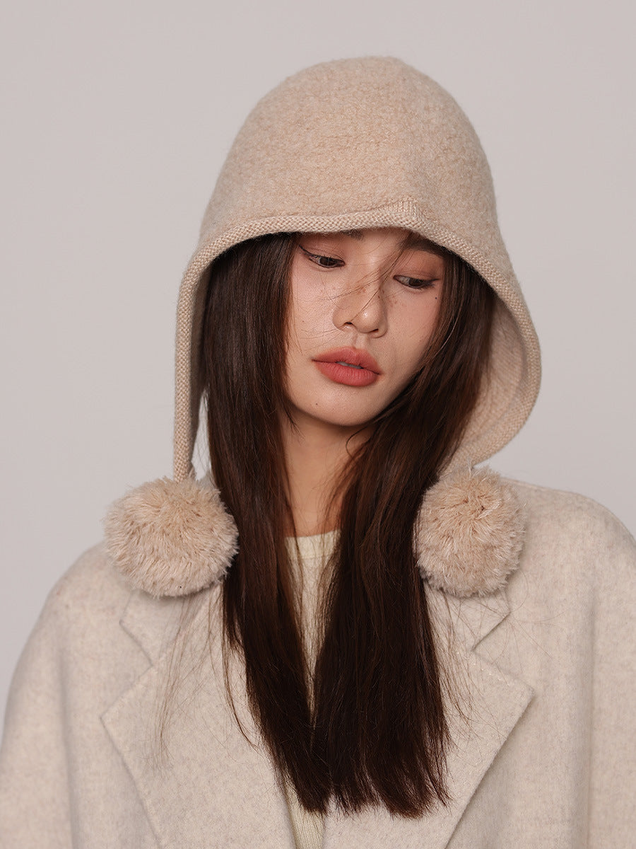 Margo & Main cream wool pom pom hood — front view with the poms resting at the collarbone