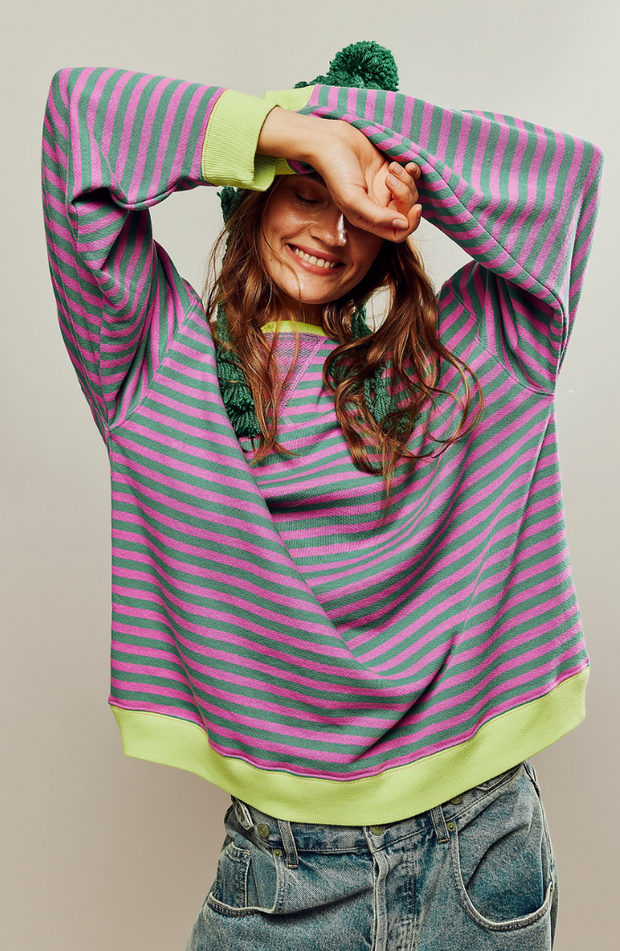 Margo & Main – green & pink striped sweater front view with arms raised, US women's sizes